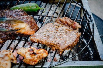 Assorted delicious grilled meat with Shrimp and vegetables over the coals on barbecue