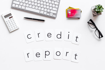 credit report text with credit cards and keyboard on banker work place white background top view