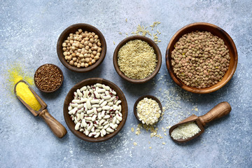 Assortment of grains, cereals and legumes in a bowls. Top view with copy space.