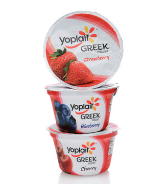 IRVINE, CA - SEPTEMBER 15, 2014: A stack of three different containers of Yoplait Greek Yogurt. In 1965, two French dairy co-operatives, Yola and Coplait, merged, becoming Yoplait.  
