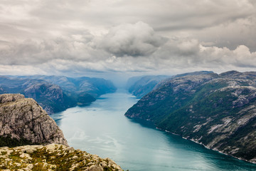 Panoramic mountain view to the long narrow and blue Lysefjord, Prekestolen hiking trail, Forsand, Rogaland county, Norway.