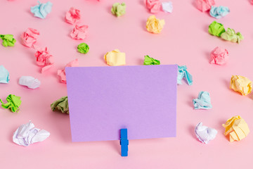 Colored crumpled papers empty reminder pink floor background clothespin