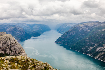 Obraz premium Panoramic mountain view to the long narrow and blue Lysefjord, Prekestolen hiking trail, Forsand, Rogaland county, Norway.