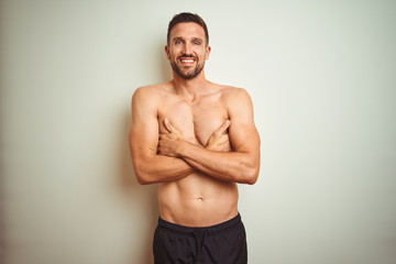Young handsome shirtless man over isolated background happy face smiling with crossed arms looking at the camera. Positive person.