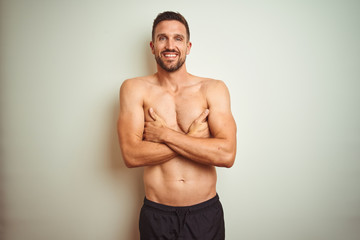 Fototapeta premium Young handsome shirtless man over isolated background happy face smiling with crossed arms looking at the camera. Positive person.