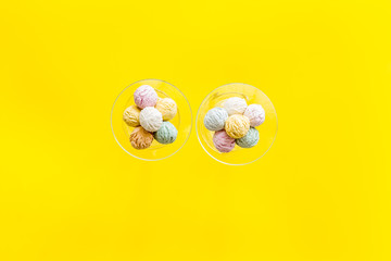 Ice-cream scoops in vase on yellow backgroung top view mockup