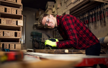 Confident young male carpenter in his workshop