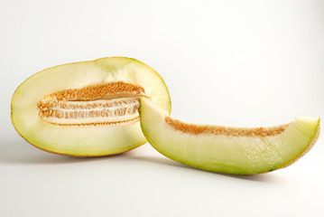 piece of ripe melon with seeds on a white background