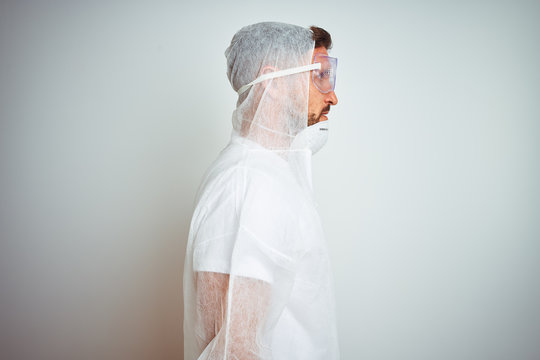 Painter man wearing professional worker equipment protection over isolated background looking to side, relax profile pose with natural face with confident smile.