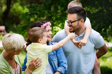 Happy family enjoying picnic in nature at summer