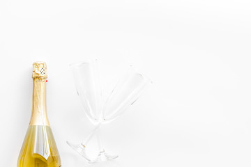 Champagne bottle with glasses for celebration on white background top view mock up