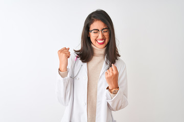 Chinese doctor woman wearing coat and pink stethoscope over isolated white background very happy and excited doing winner gesture with arms raised, smiling and screaming for success. 