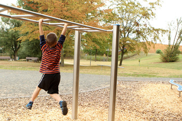 Obraz premium boy, preschooler, primary school student walks his hands on a sports apparatus, the development of physical and motor activity, developing, sports concept