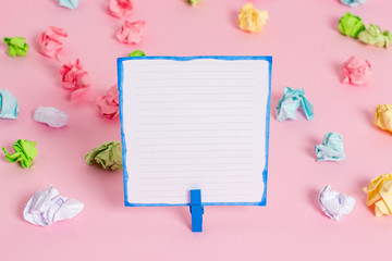 Colored crumpled papers empty reminder pink floor background clothespin