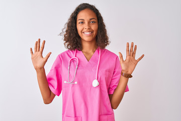 Young brazilian nurse woman wearing stethoscope standing over isolated white background showing and...