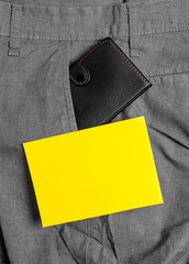 Small little wallet inside man trousers front pocket near notation paper