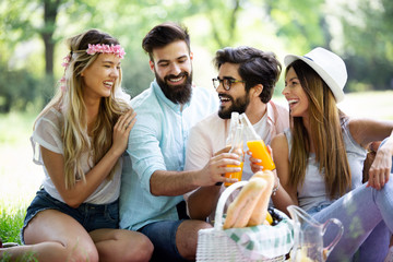 Summer, vacation, music and recreation time concept. Group of friends have picnic outdoor.