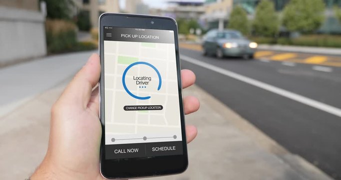 A man holds a smartphone running an ride sharing app. The screen reads Locating Driver. Fictional interface.	 	