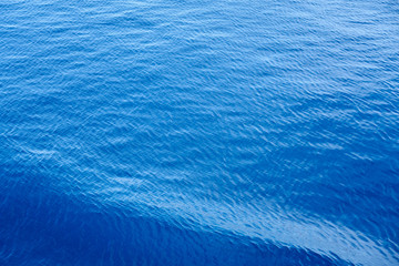 Obraz premium Blue waving sea water as a natural background texture.