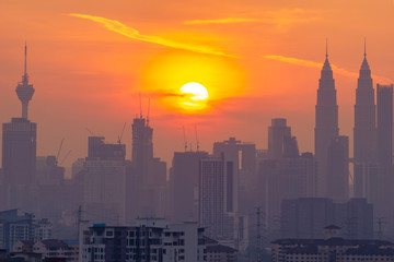 Fototapeta na wymiar KUALA LUMPUR, MALAYSIA - 11th AUGUST 2019; Cloudy and haze sunset view over down town Kuala Lumpur, Malaysia.