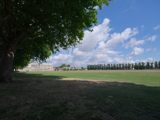 green landscape and blue sky with clouds