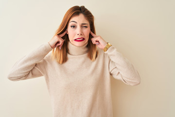 Redhead woman wearing elegant turtleneck sweater standing over isolated white background covering...