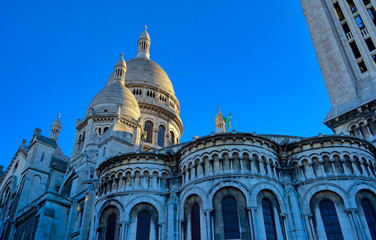 Fototapeta na wymiar The Basilica of the Sacred Heart of Paris, located in the Montmartre district of Paris, France.