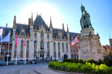 Naklejka premium Bruges, Belgium - April 26, 2019 - The Provinciaal Hof (Province Court) is a Neogothical building on the market place in Bruges, Belgium.