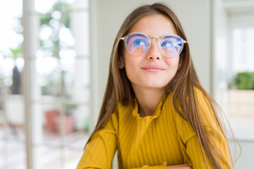 Fototapeta na wymiar Beautiful young girl kid wearing glasses smiling looking side and staring away thinking.