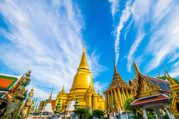 Emerald buddha temple golden pagoda blue sky with cloud sightseeing in Bangkok