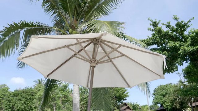 White parasols blowing in the wind, close up