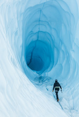 Walking toward an ice cave with deep blue ice  on the Matanuska Glacier in Alaska - obrazy, fototapety, plakaty