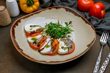 Caprese salad with mozzarella and tomato and aragula