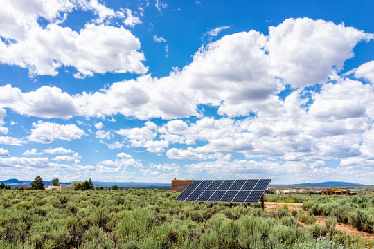 Taos Sangre De Cristo Mountains View From Ranchos De Taos Valley And Green Landscape In Summer And Solar Panel With Clouds