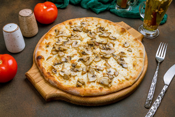pizza with mushrooms on dark rustic background