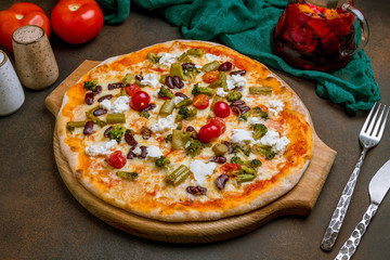 Pizza with vegetables vegetarian on dark rustic background