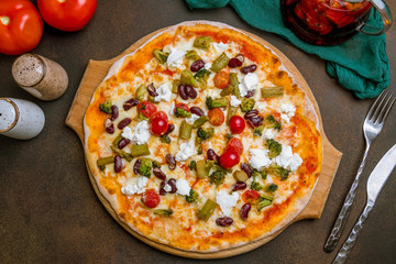 Pizza with vegetables vegetarian on dark rustic background