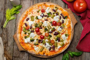 Pizza with vegetables vegetarian on old wooden table