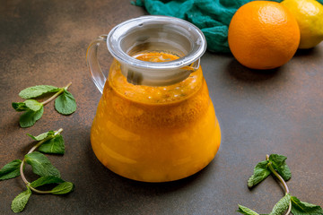 sea buckthorn tea in the teapot  on dark rustic background