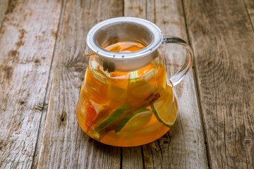Hot Tea with citrus on old wooden background