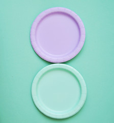 Colorful paper plates on light background.