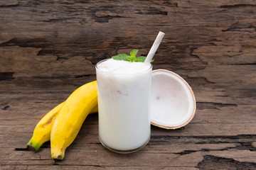Banana fresh cocktail vanilla smoothies juice and White banana fruit beverage healthy the taste yummy In glass for for milkshake on wooden background.
