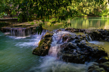 Fototapeta na wymiar Waterfall in deep tropical rainforest with green tree
