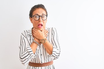 Middle age businesswoman wearing striped dress and glasses over isolated white background shouting suffocate because painful strangle. Health problem. Asphyxiate and suicide concept.