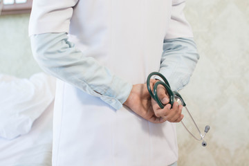 body part of female hand holding stethoscope close up