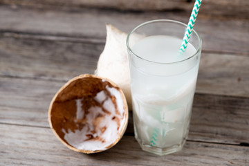 Fresh coconut juice in a glass with coconut white meat isolated on white