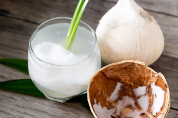 Fresh coconut juice in a glass with coconut white meat isolated on white