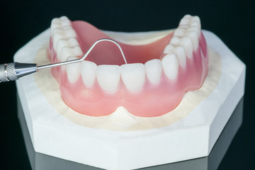 Close up , Complete denture or full denture on black background.