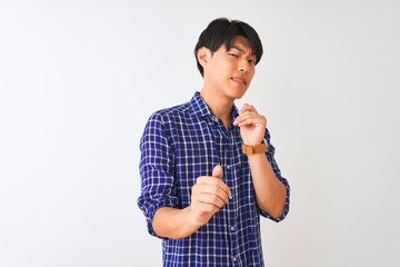 Young chinese man wearing casual blue shirt standing over isolated white background disgusted expression, displeased and fearful doing disgust face because aversion reaction. With hands raised. 