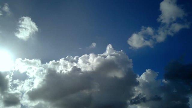 Clouds Float Peacefully Through Blue Sky